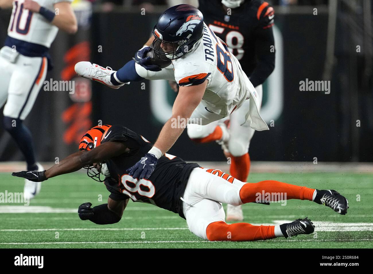 Denver Broncos tight end Adam Trautman is tackled by Cincinnati Bengals ...