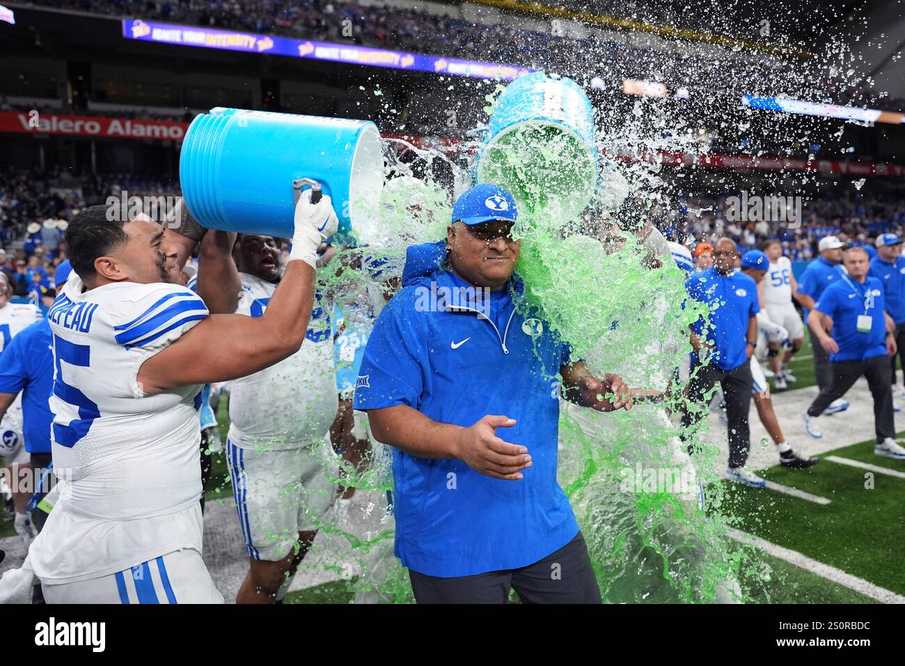 BYU head coach Kalani Sitake, center, is doused as he and his players