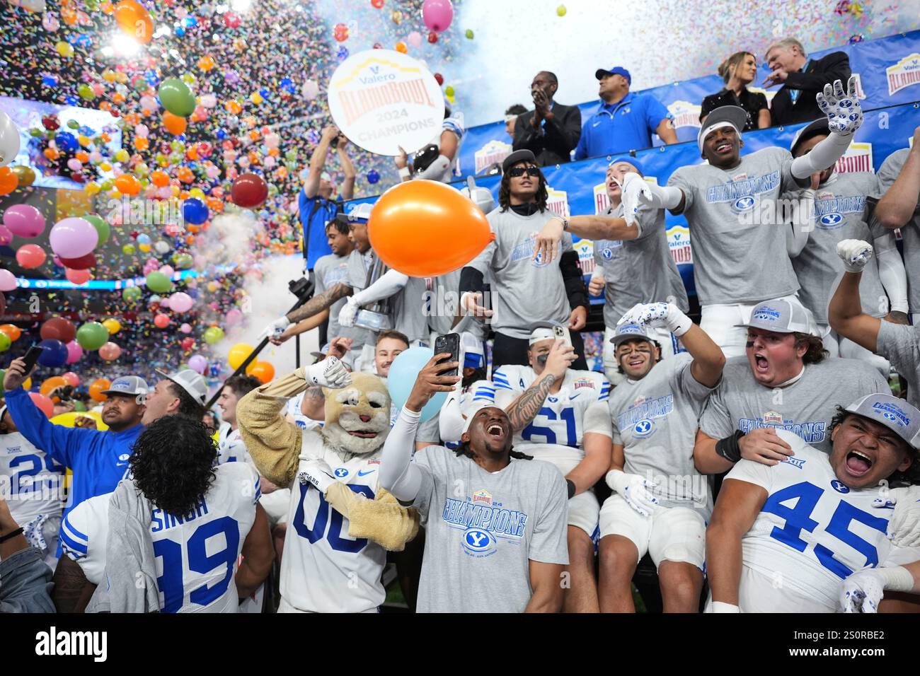 BYU players and coaches celebrate after their win over Colorado in the
