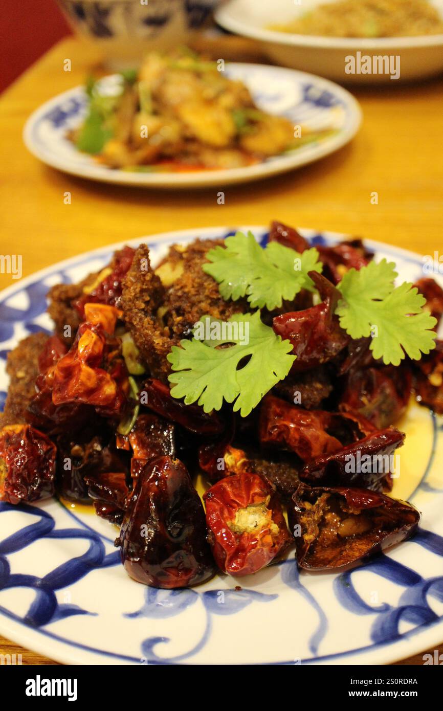 Sichuan cuisine (Chinese cuisine): fried beef and chili peppers with coriander Stock Photo