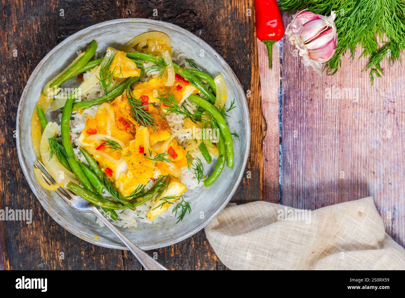 Ginger and tumerick cod with green beans and rice Stock Photo