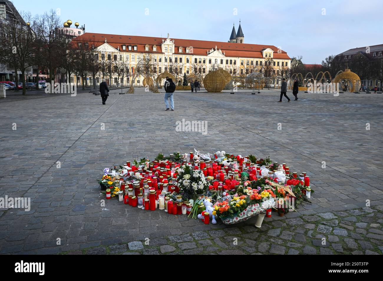 Flowers and candles are seen on a place of remembrance for the victims