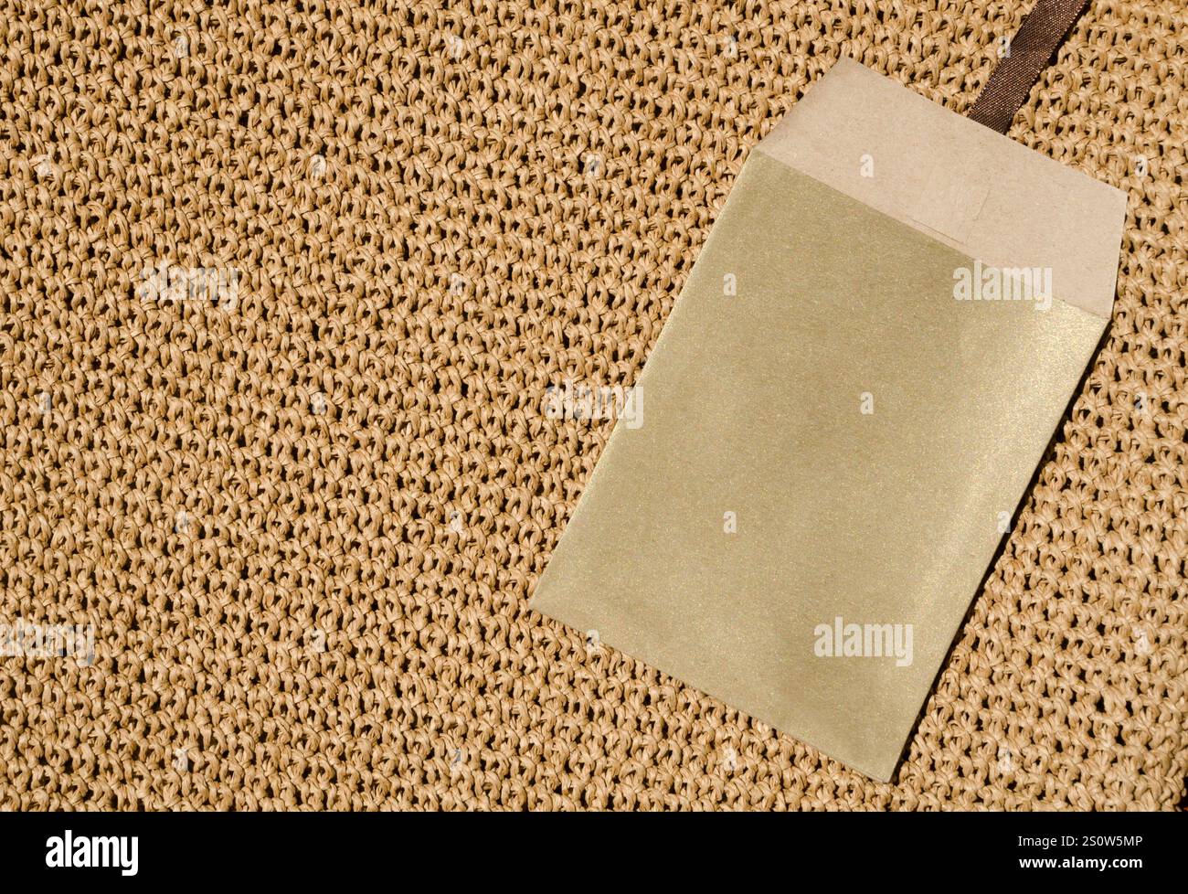 Paper envelope on a seamless knitted pattern. The background is ...