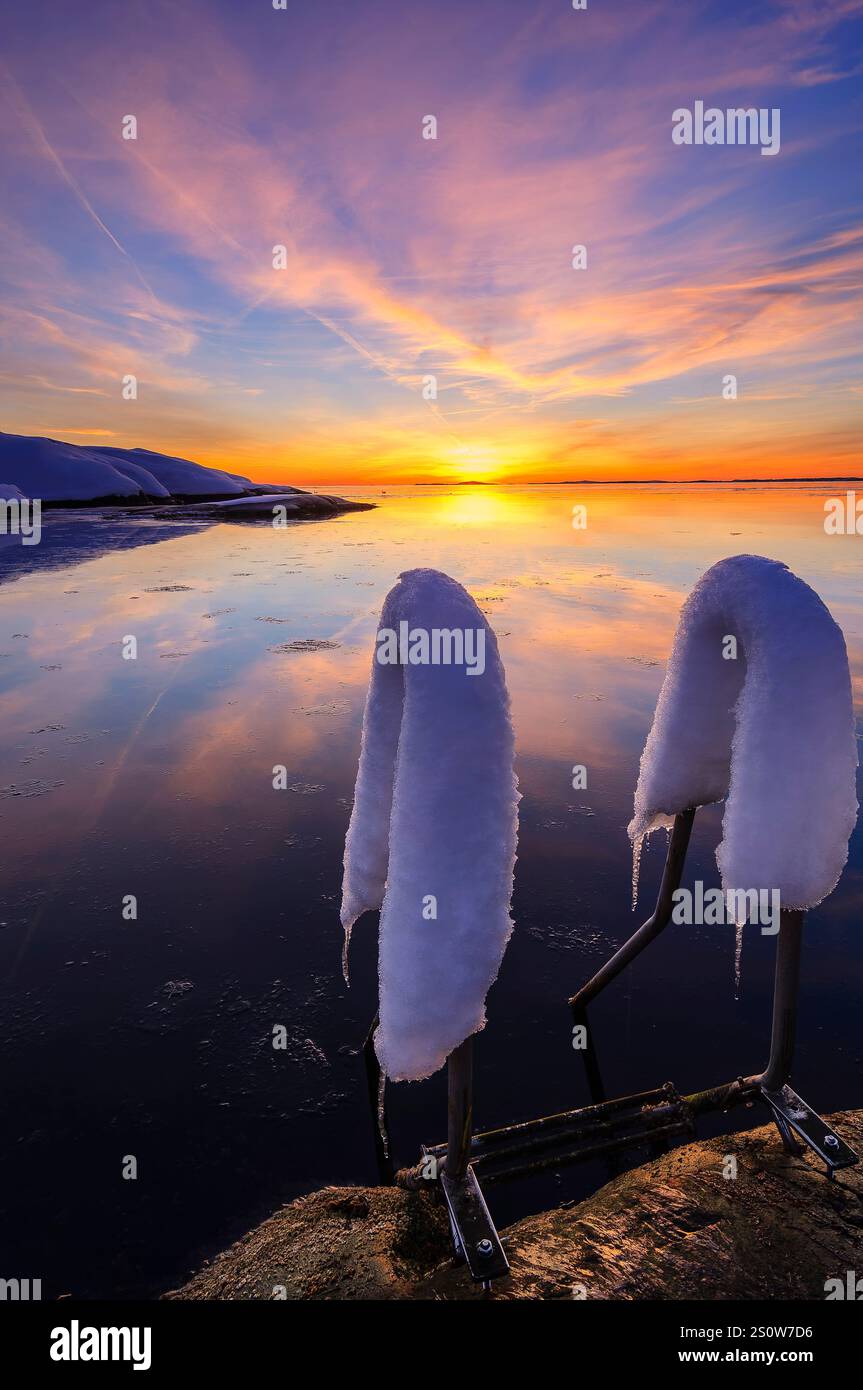 A breathtaking sunset illuminates the sky with vibrant colors above a ...