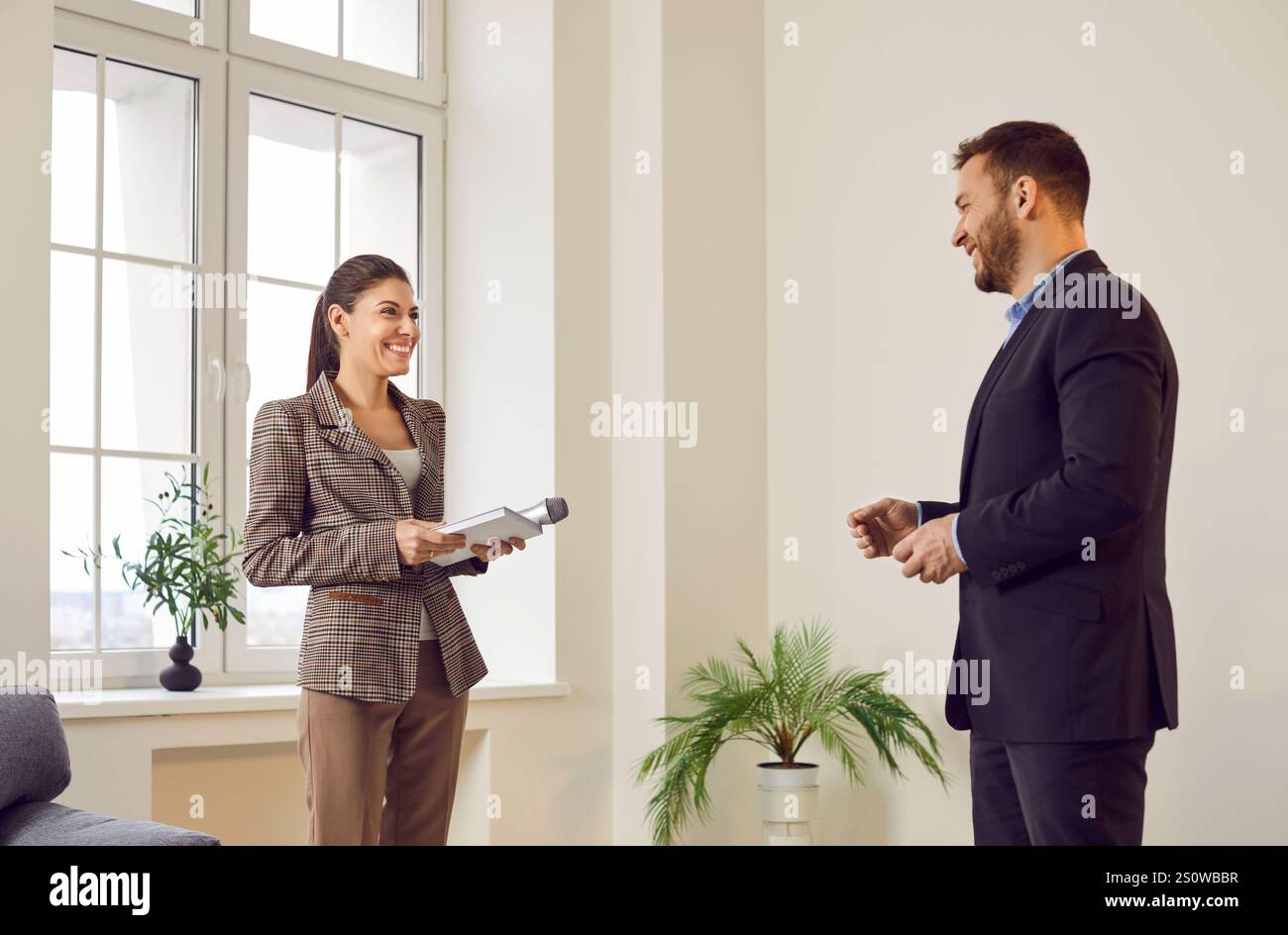 Female Reporter Conducting Interview With Businessman For Tv Show Or Press Stock Photo