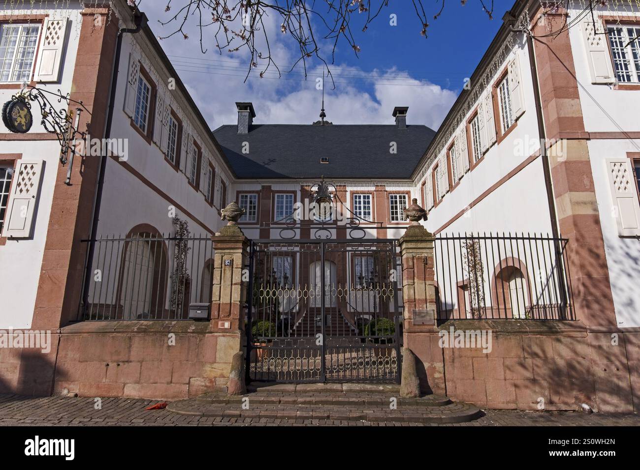 An imposing historic building in baroque style with a lattice gate and ...
