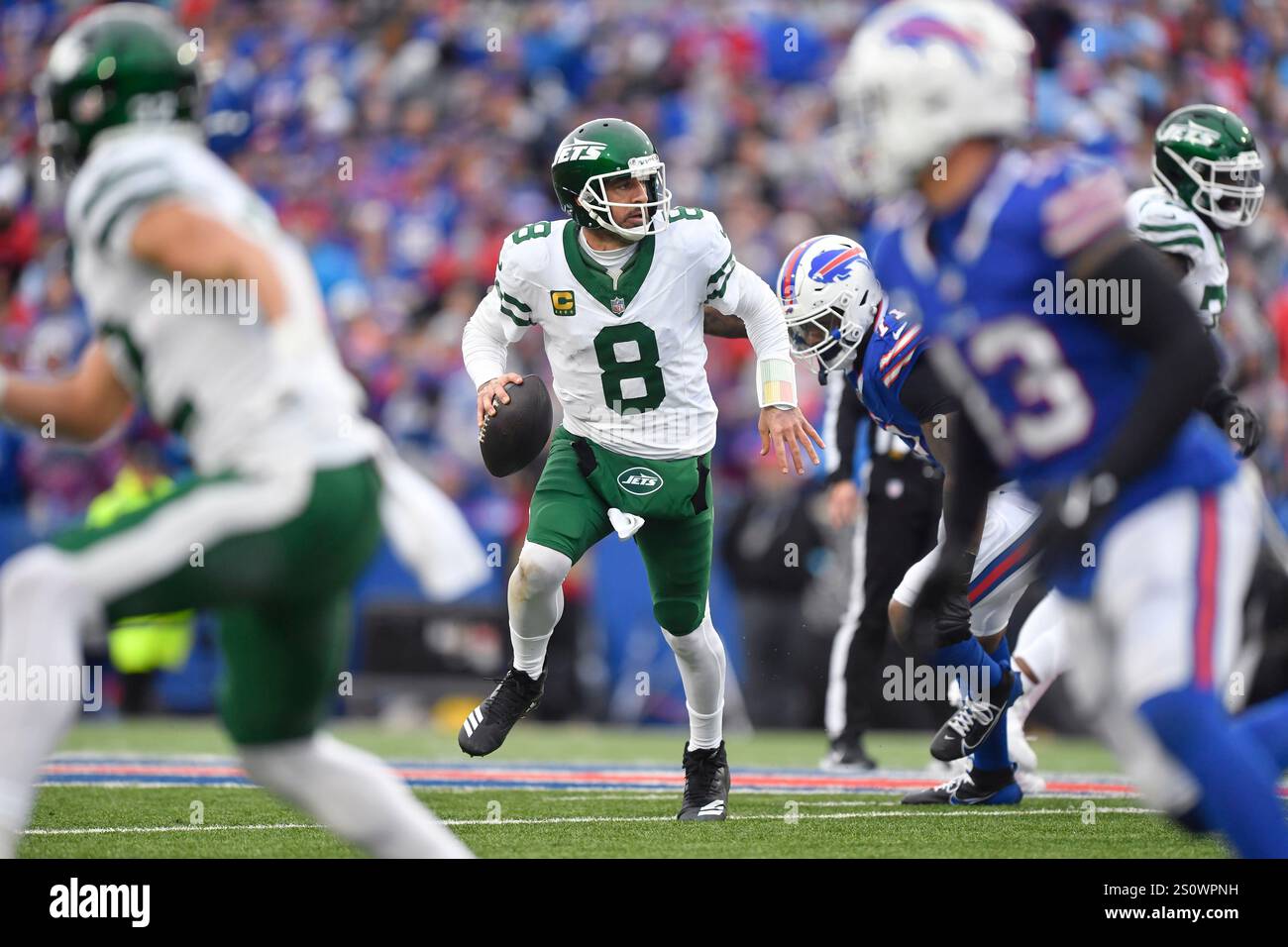 New York Jets quarterback Aaron Rodgers (8) scramble as he looks to