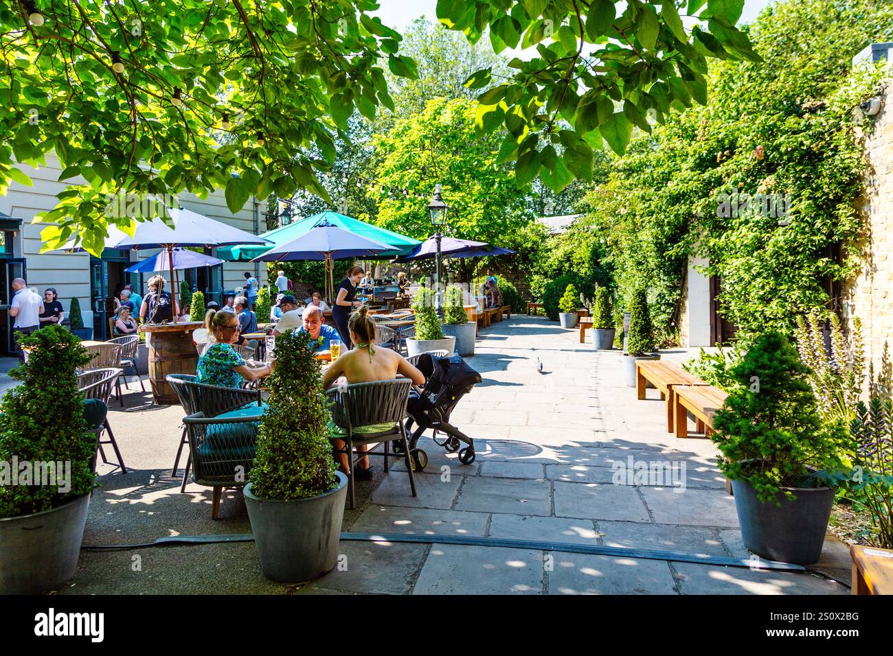 People sitting in the garden of the Old Brewery Pub, Greenwich, London, England Stock Photo