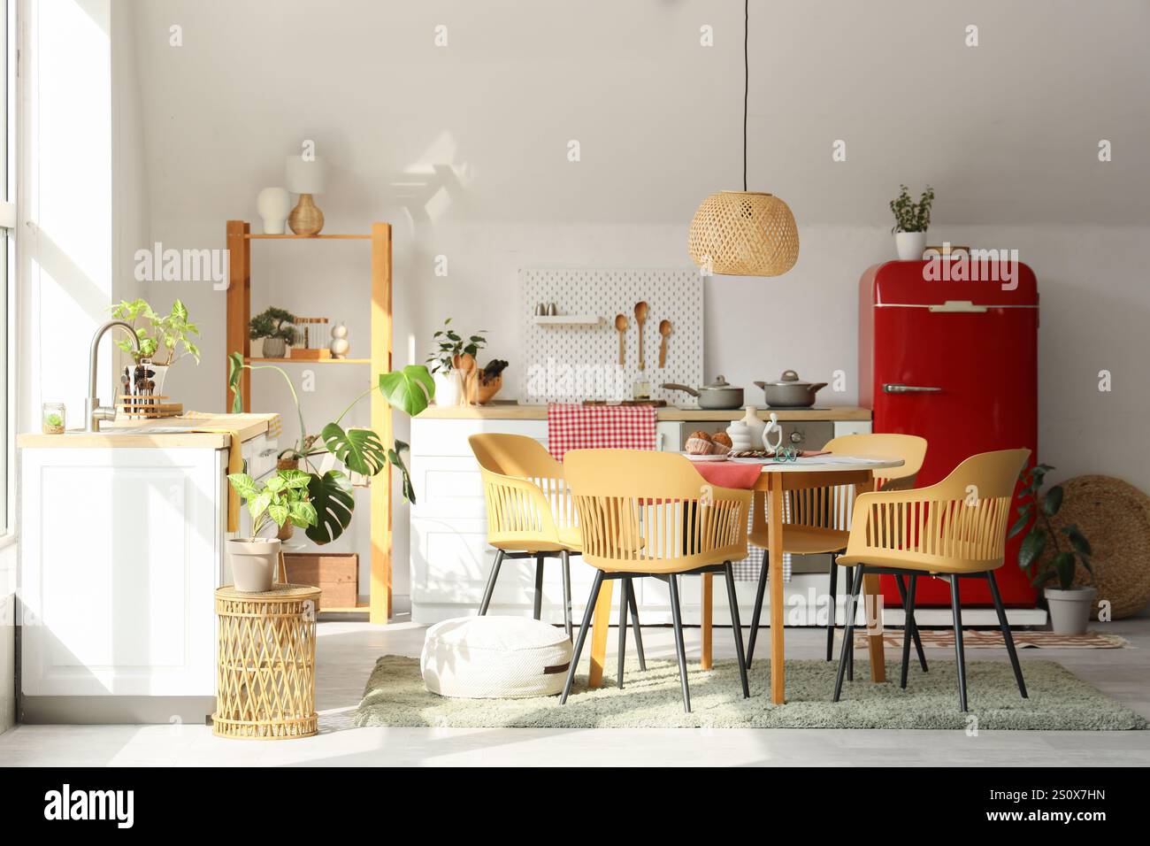 Interior of light kitchen with counters, dining table and shelf unit ...