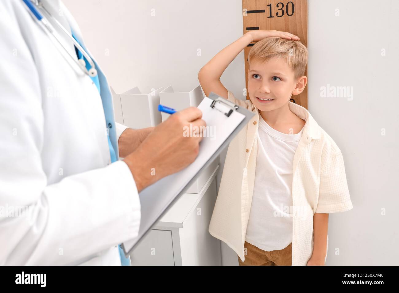 Little boy measuring his height at pediatrician's office Stock Photo ...