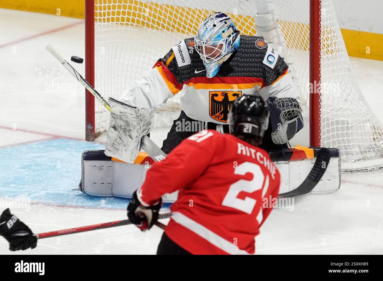 Canada forward Calum Ritchie (21) fires the puck wide past Germany ...