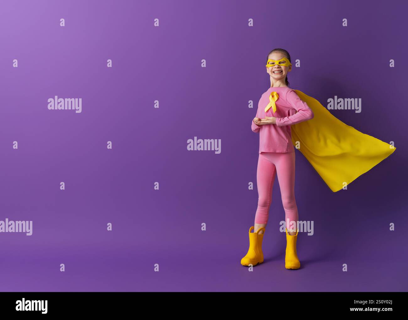 World Childhood cancer Day. Girl in superhero costume with golden ...