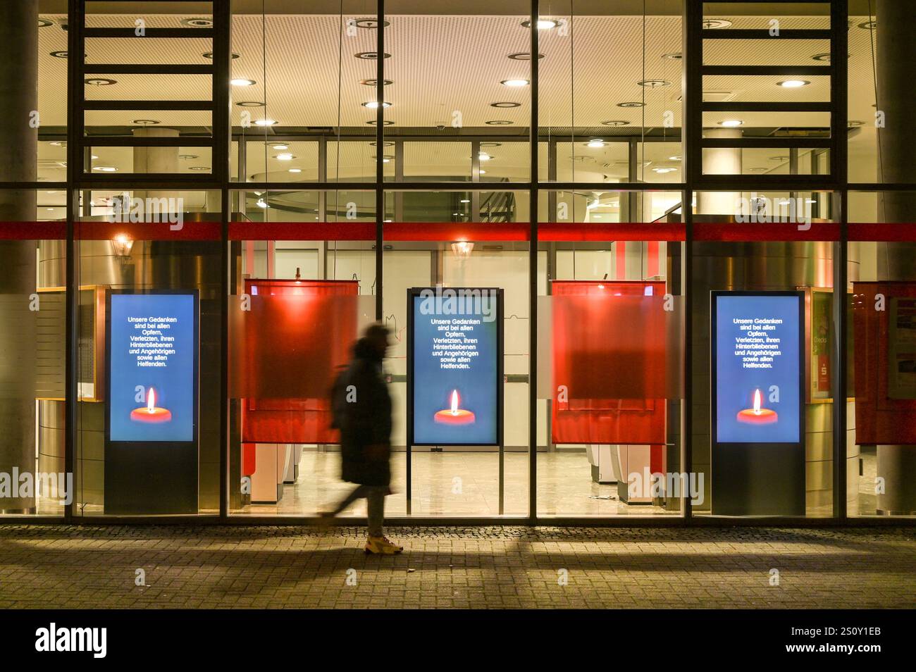 30 December 2024, Saxony-Anhalt, Magdeburg: Screens with a mourning