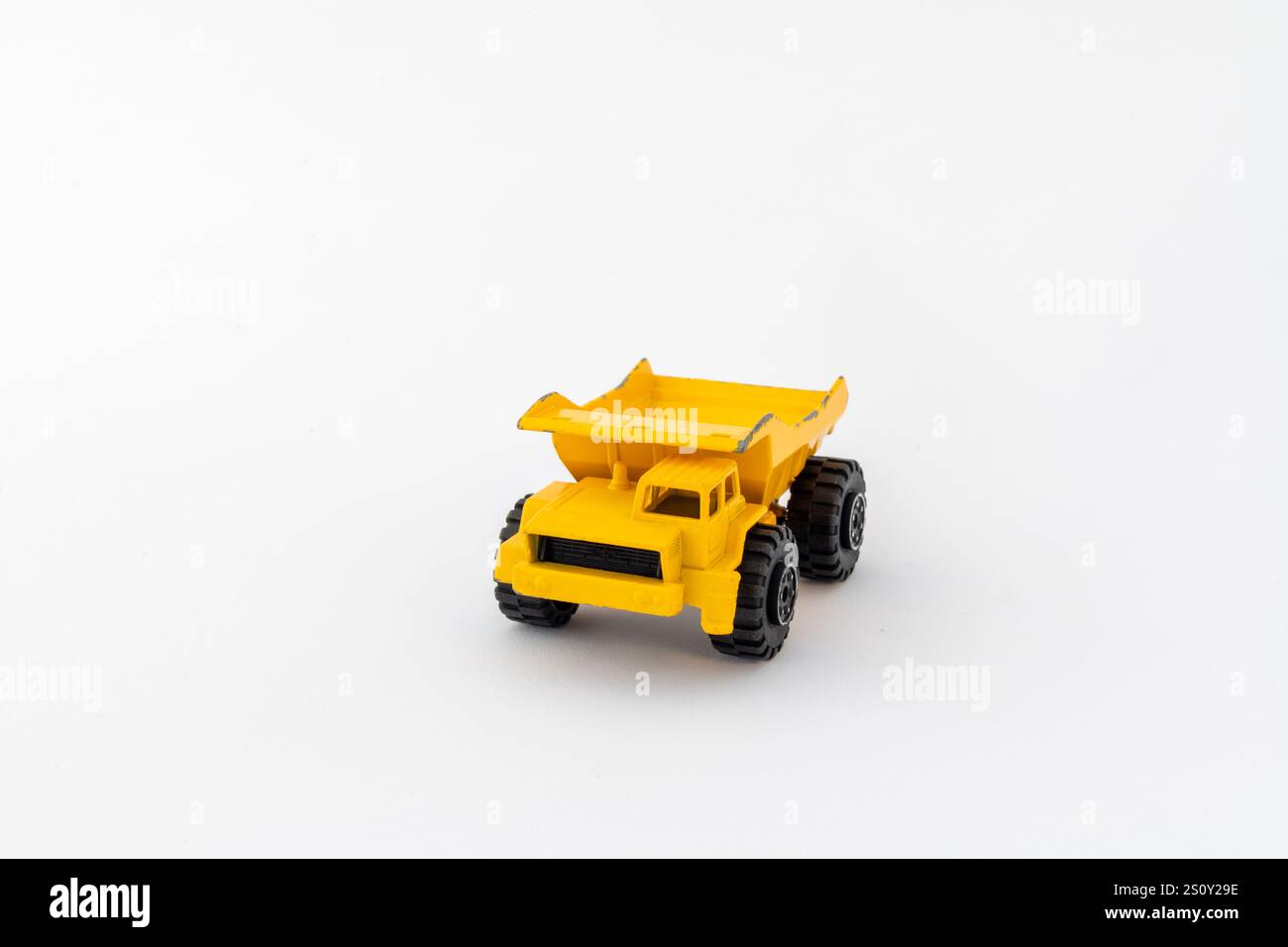 Yellow old dump truck isolated on white background Stock Photo - Alamy