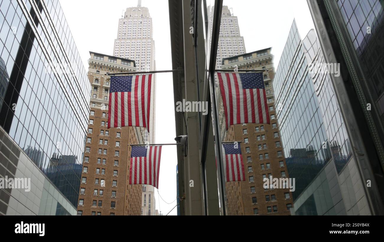 New York, american flag waving. Empire State Building. Manhattan ...