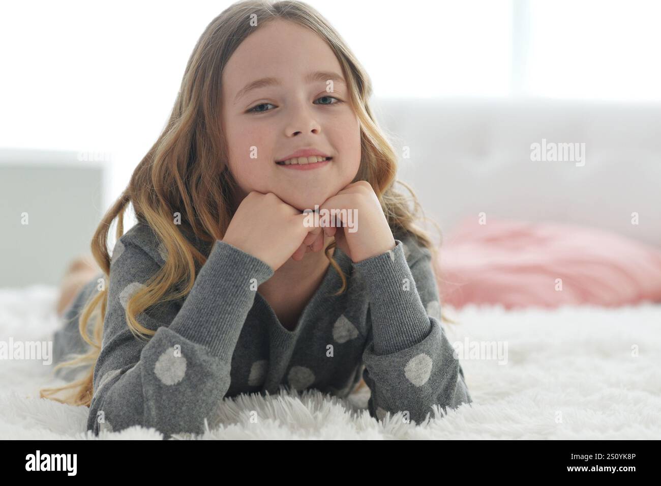 A cute little girl lying on the bed Stock Photo - Alamy