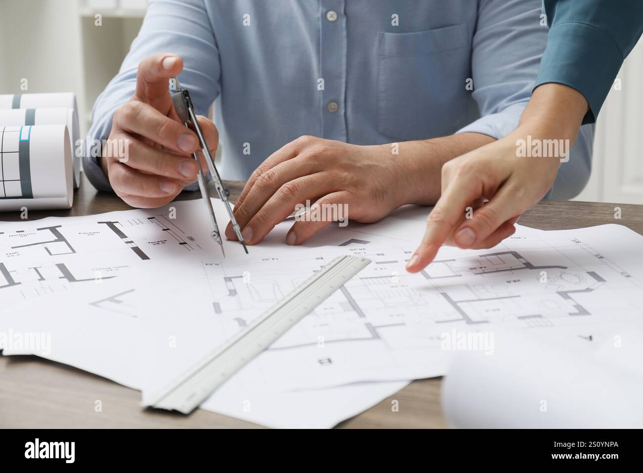 Architects working with project, closeup. Different technical drawings on wooden table Stock Photo