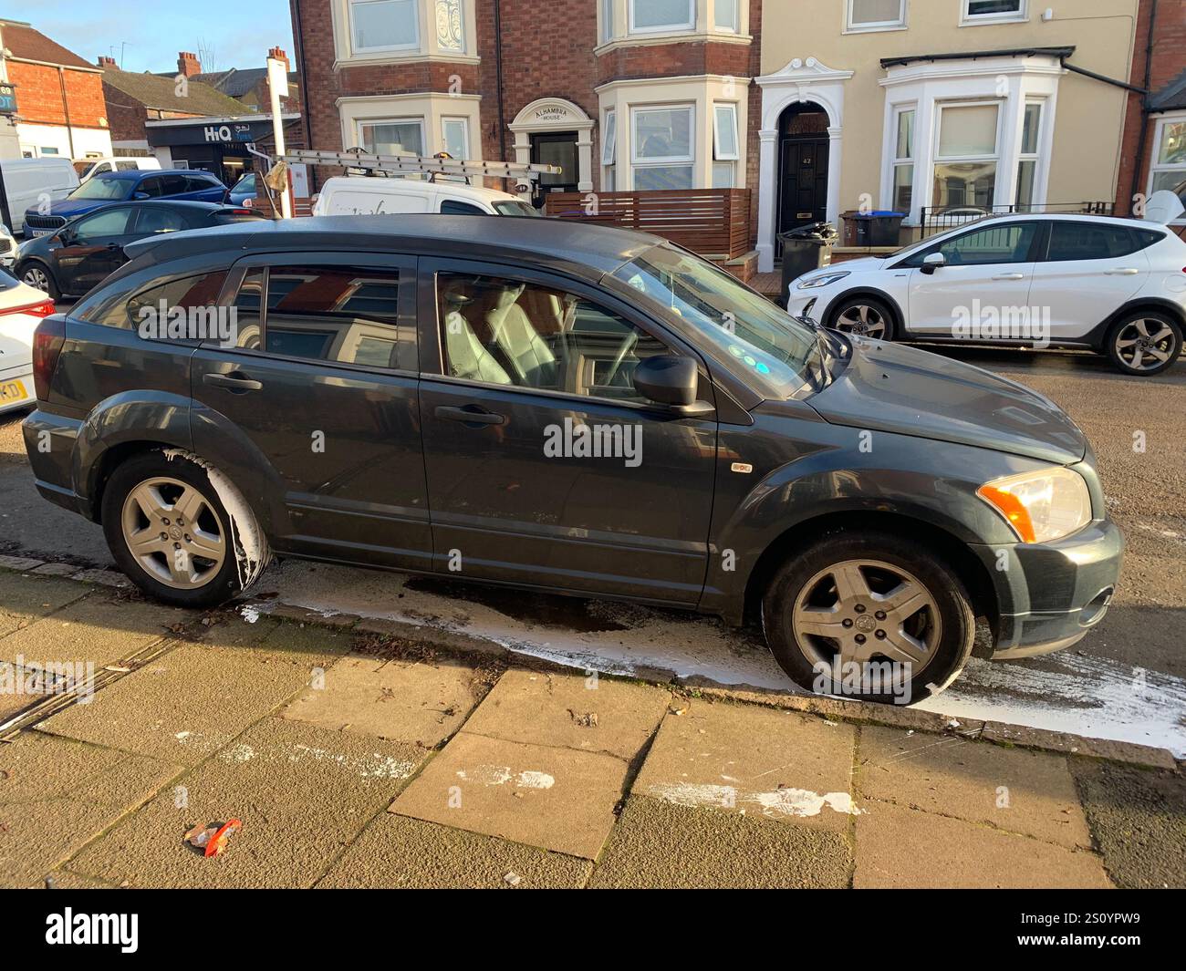 paint in street in gutter wet white mess street car damage damaged Northampton town trod trodden footprints outside cars left Christmas walk walking - Smartphone Captured Stock Image