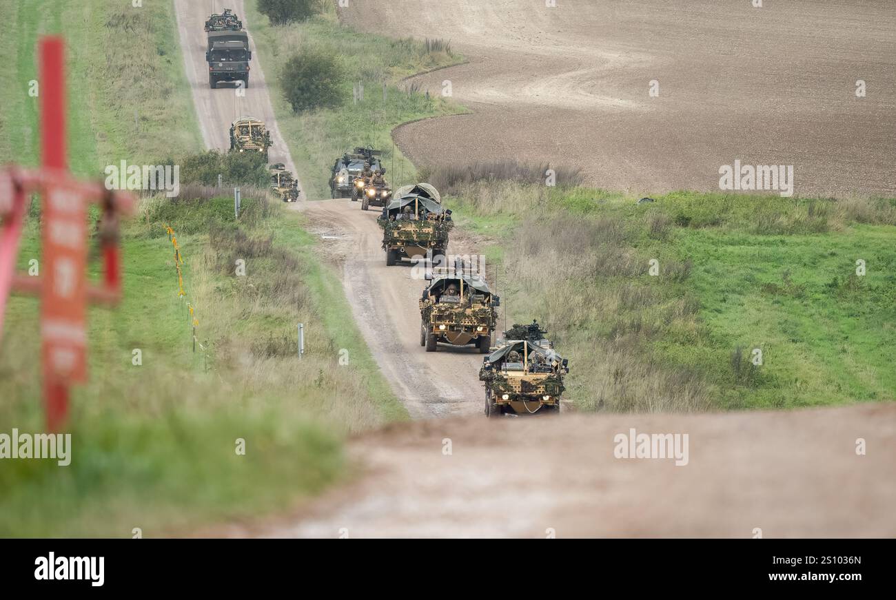 a convoy of British army Supacat Jackal and Coyote rapid assault, fire support and reconnaissance vehicles Stock Photo