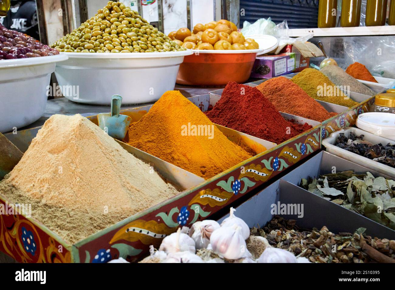 ground spices dry herbs olives and fresh food on display in a stall in the jewish food market marrakesh, morocco Stock Photo
