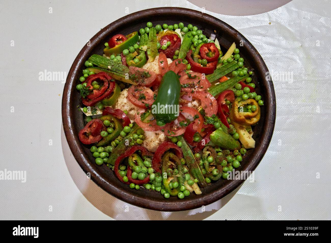 prepared vegetarian tagine of peas, pepper, tomatoes, carrot, potato, sweet potato and cauliflower part of a cookery course marrakesh, morocco Stock Photo