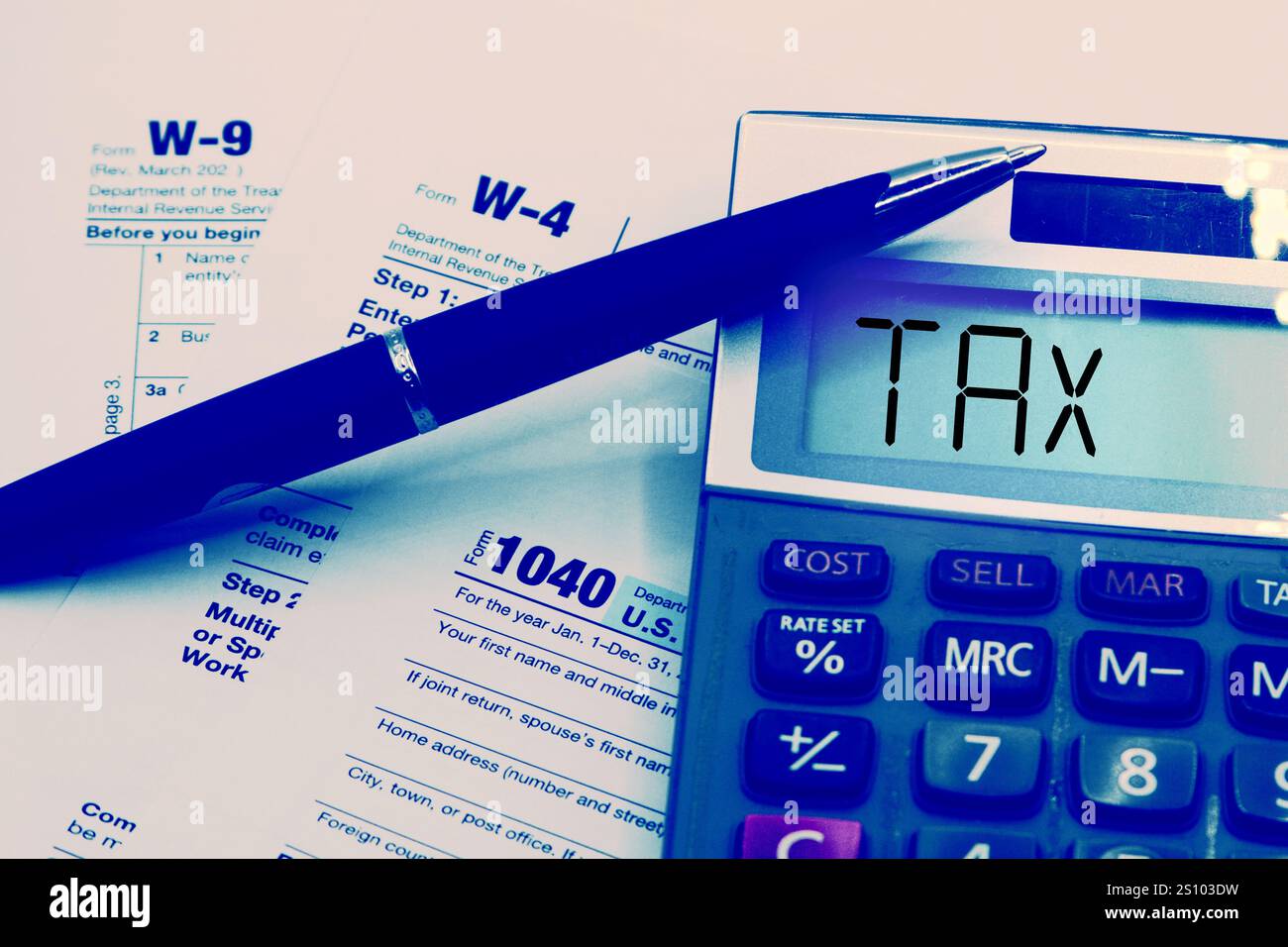 Calculator on blank 1040 w4 w9 tax form taxation concept stock photo