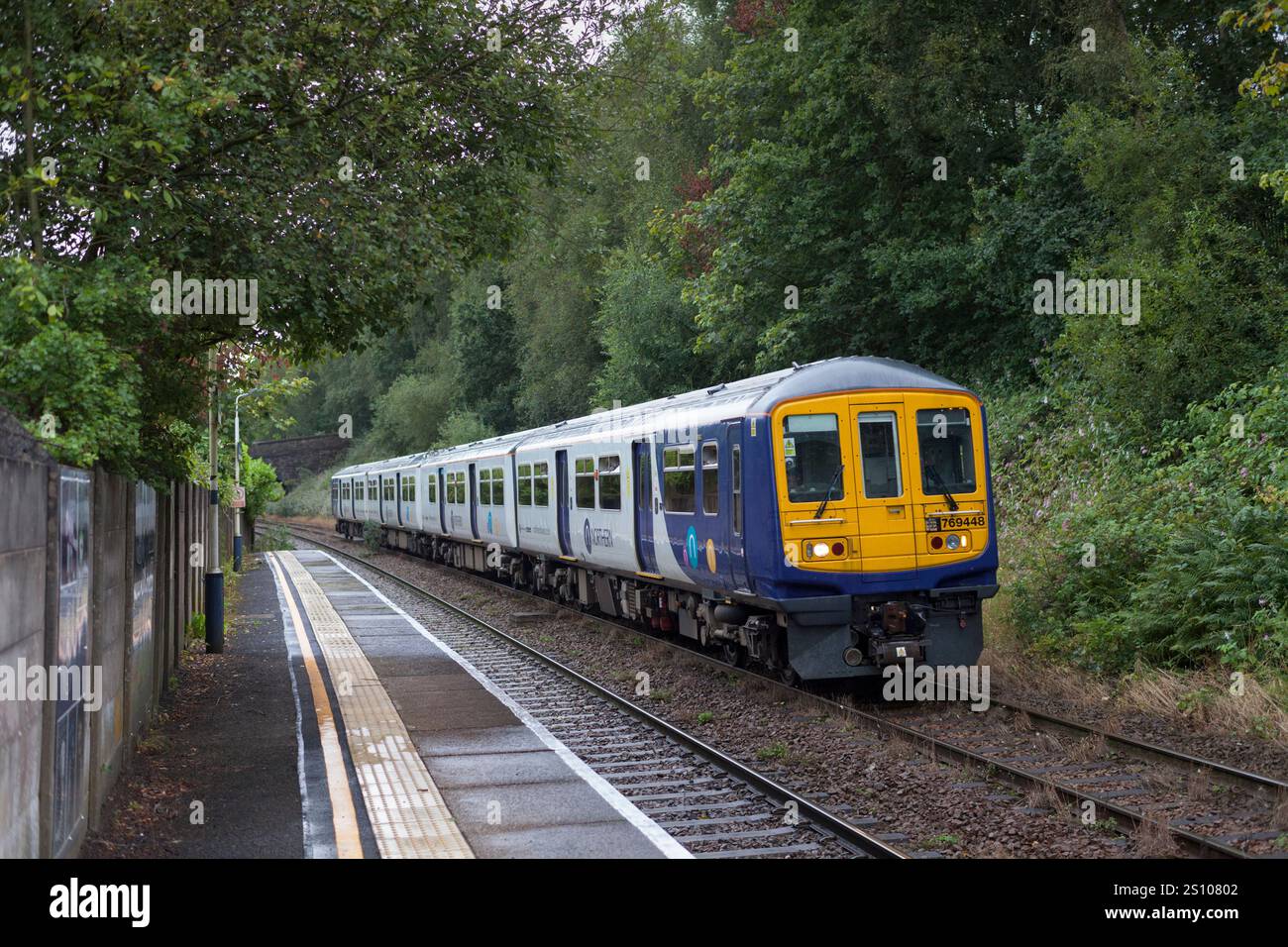 Northern Rail class 769 bi-mode train 769448 at Gathurst railway station while running on diesel Stock Photo