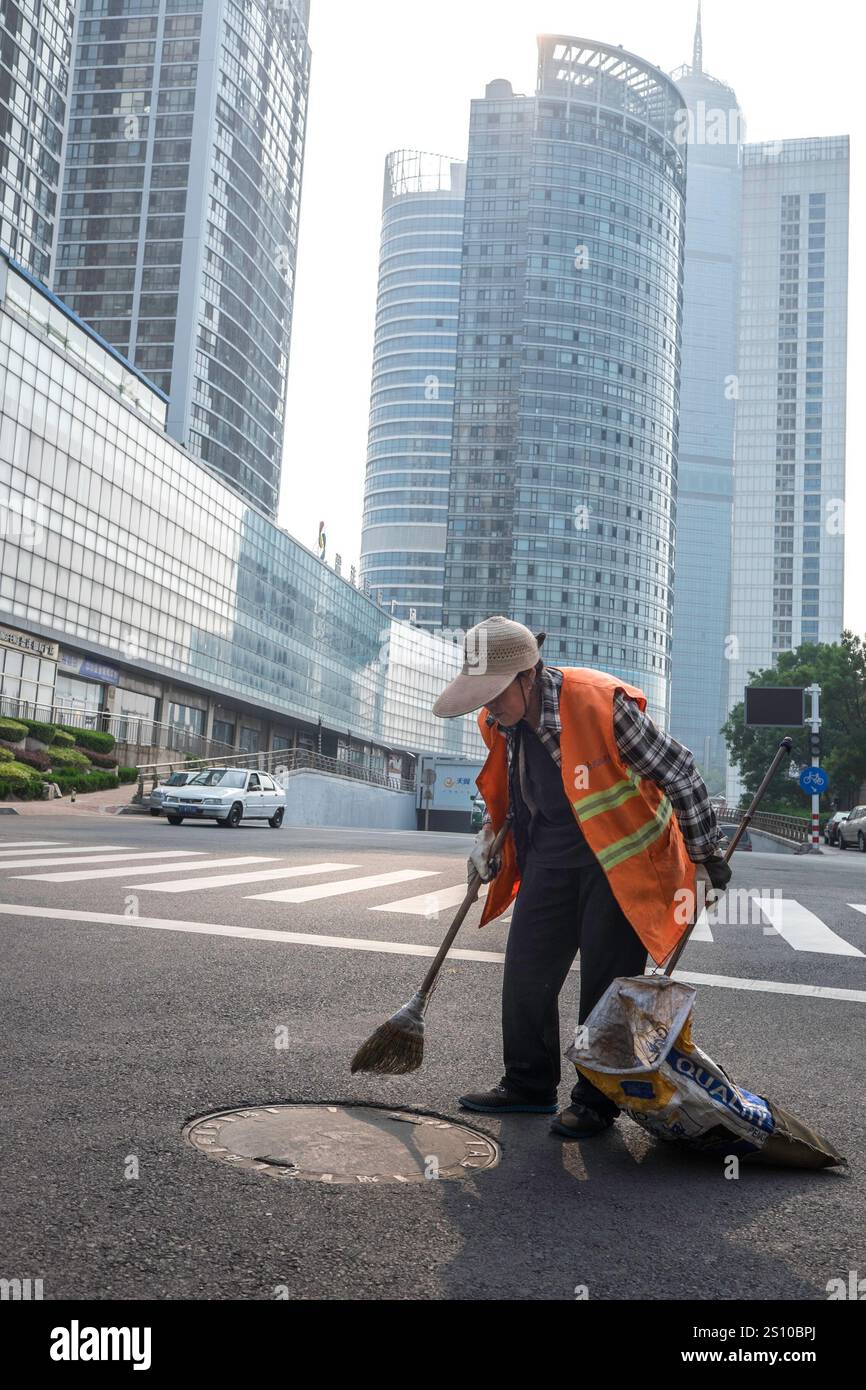 China, Yantai, 2015-06-11, broom, sweeper, architecture, street, city, building, modern city, offices, real estate Stock Photo