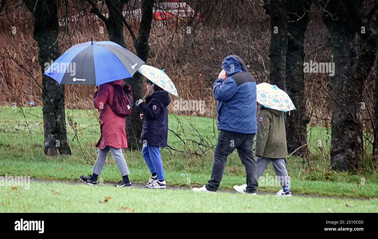 Glasgow, Scotland, UK. 30th December, 2024.  UK Weather: Wet , windy and dull shopping on buchanan street, the style mile and shopping capital of scotland as people cower under umbrellas amidst the squawl. Credit Gerard Ferry/Alamy Live News Stock Photo