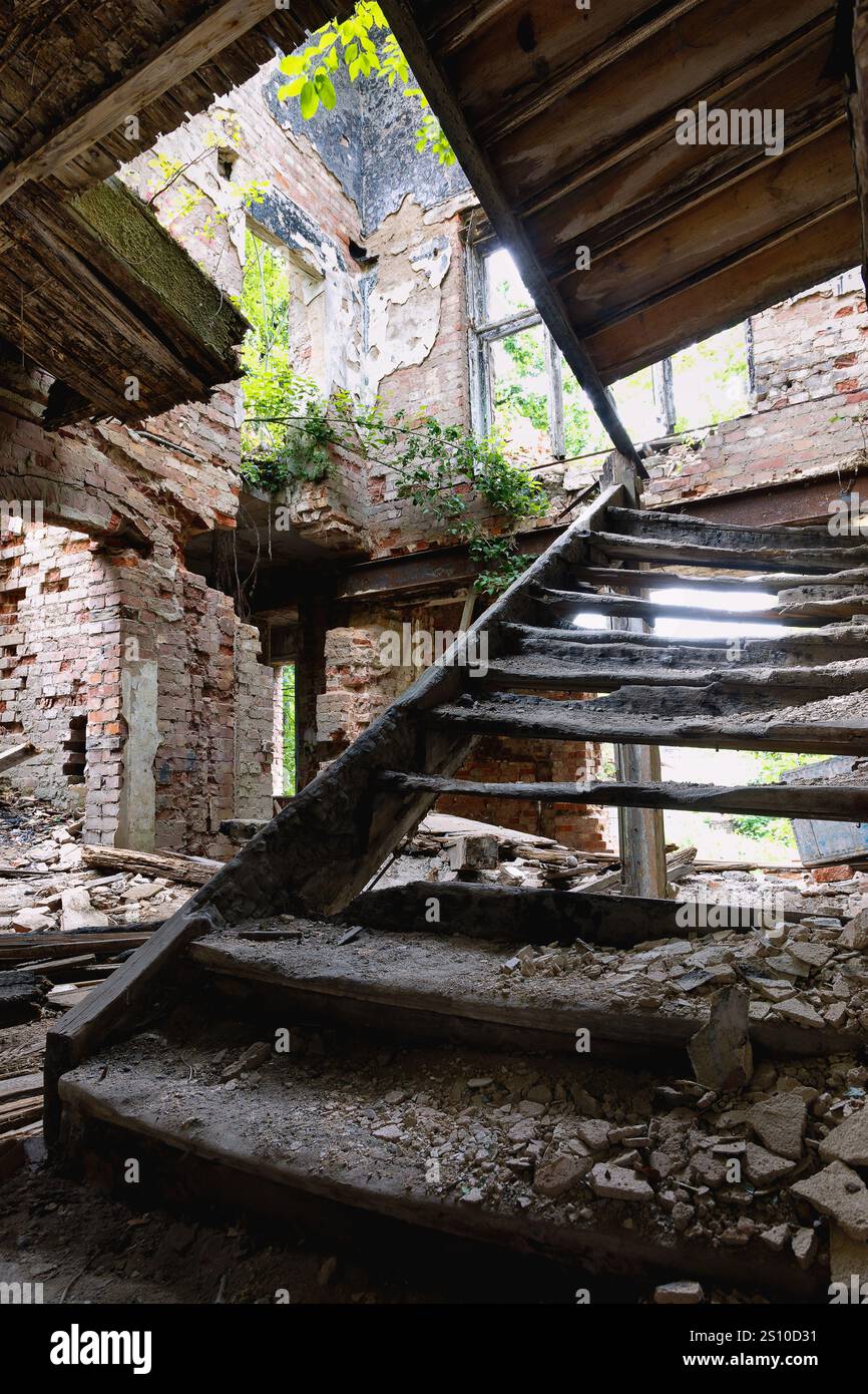 Interior with stairs of an old destroyed and burned down abandoned house Stock Photo