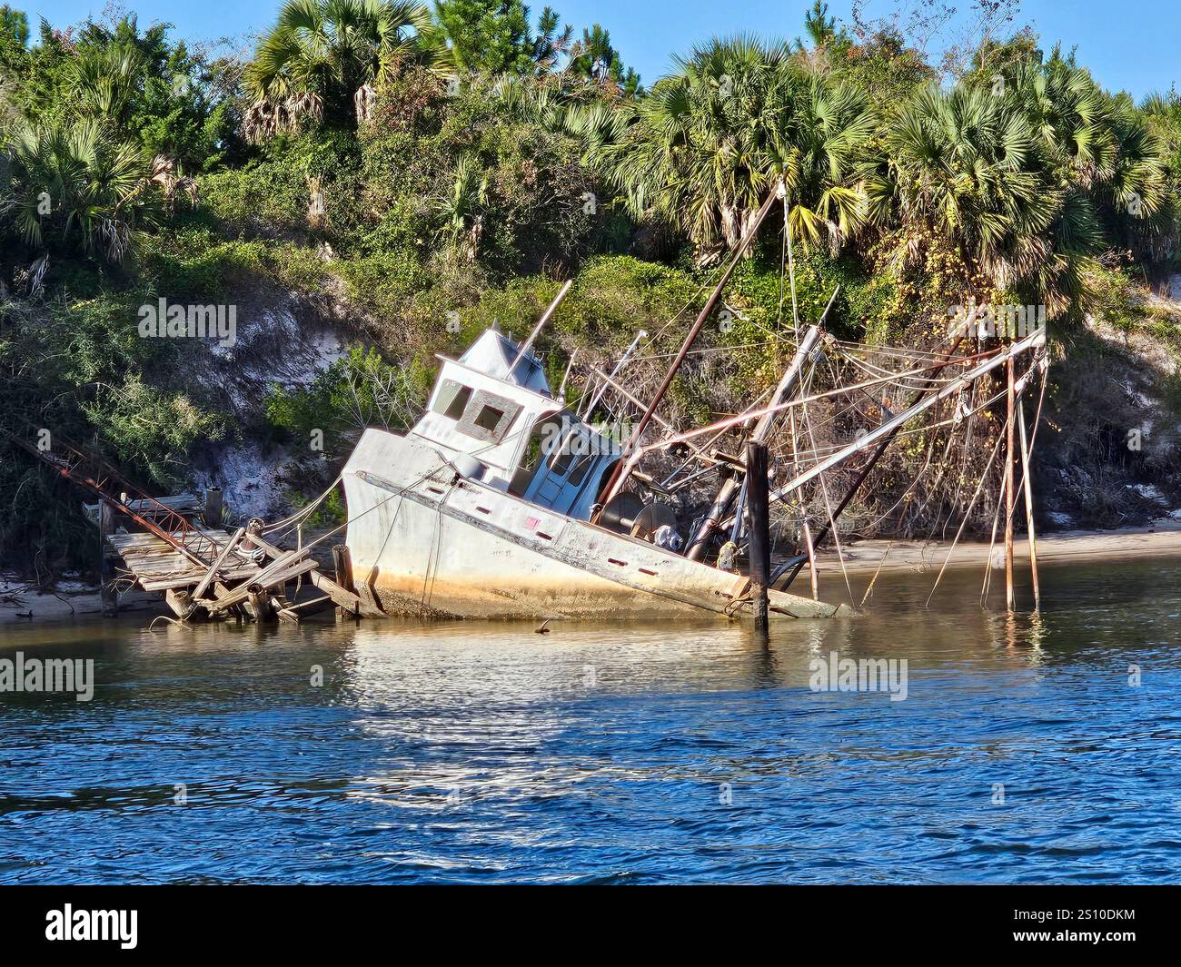 A derelict shrimp fishing boat half sunk in the canal at Port St Joe, Florida - Smartphone Captured Stock Image