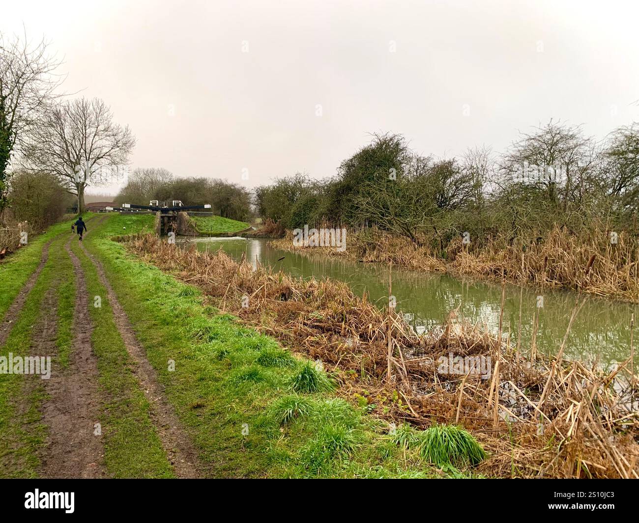 Northampton Northamptonshire boat water canal people place man walk walking countryside amble cold winter weather path track ship narrow boat - Smartphone Captured Stock Image