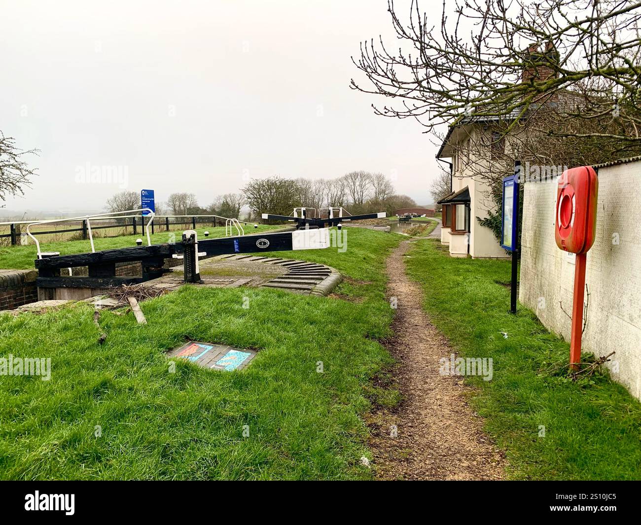 Northampton Northamptonshire boat water canal people place man walk walking countryside amble cold winter weather path track ship narrow boat - Smartphone Captured Stock Image