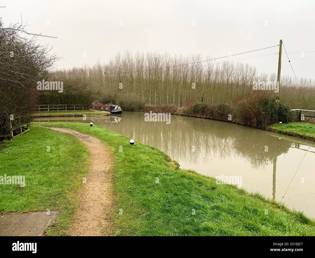 Northampton Northamptonshire boat water canal people place man walk walking countryside amble cold winter weather path track ship narrow boat - Smartphone Captured Stock Image