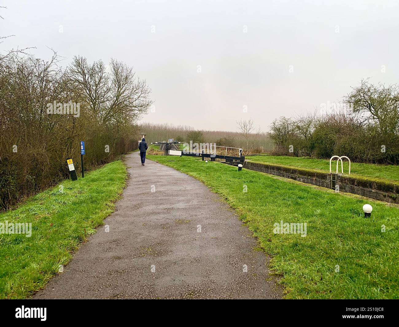 Northampton Northamptonshire boat water canal people place man walk walking countryside amble cold winter weather path track ship narrow boat - Smartphone Captured Stock Image