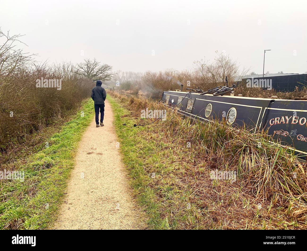Northampton Northamptonshire boat water canal people place man walk walking countryside amble cold winter weather path track ship narrow boat - Smartphone Captured Stock Image