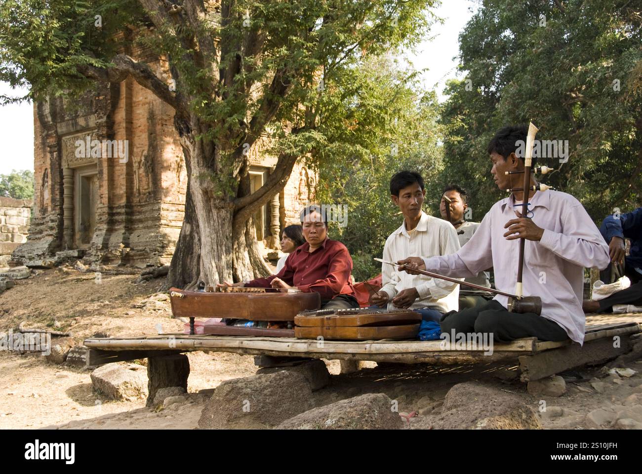 Musicians play near Bakong temple built by the Khmer empire at Angkor, near Siem Reap, Cambodia. Stock Photo