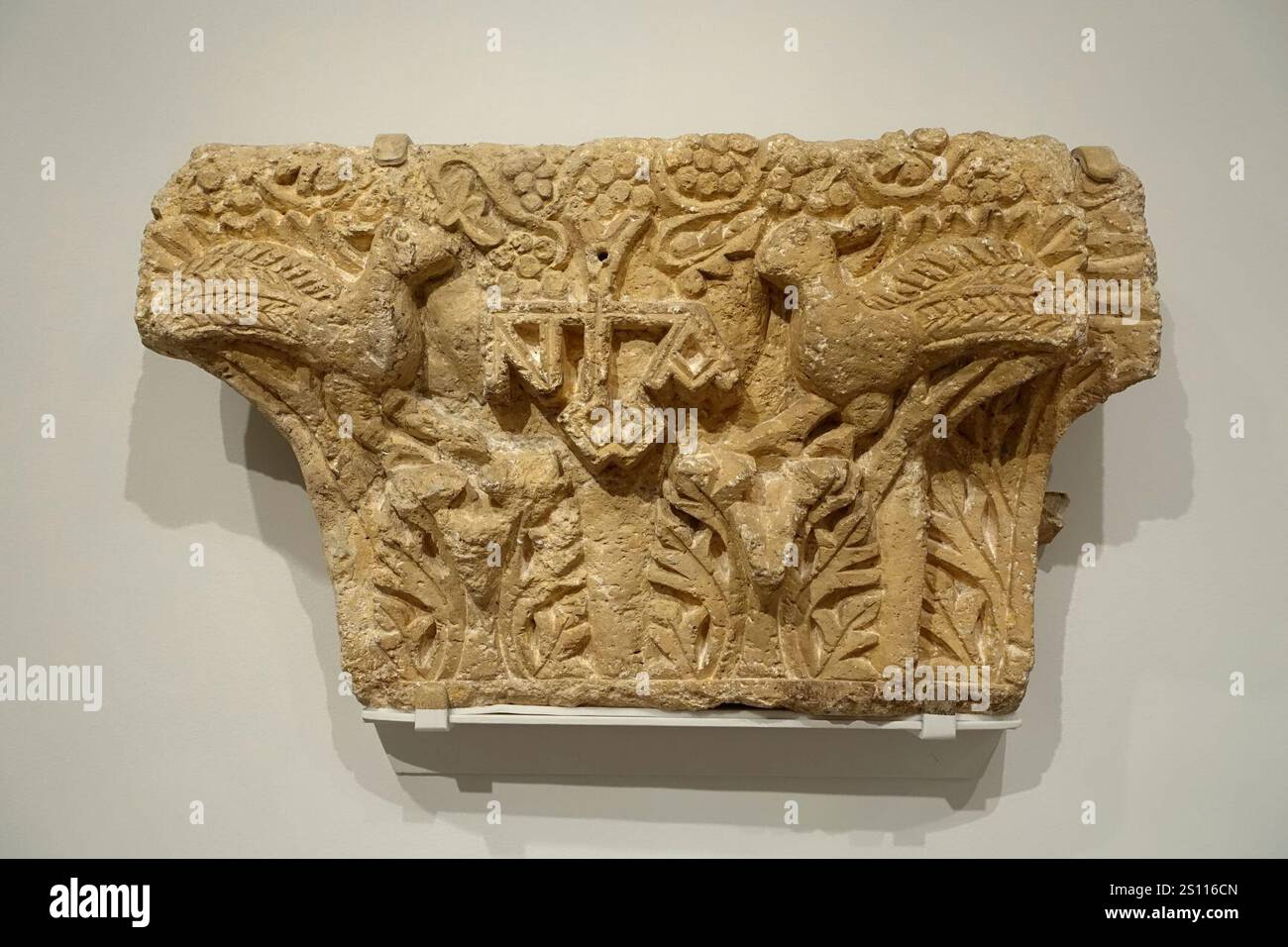 Engaged pilaster capital with monogram IOANoY flanked by peacocks ...