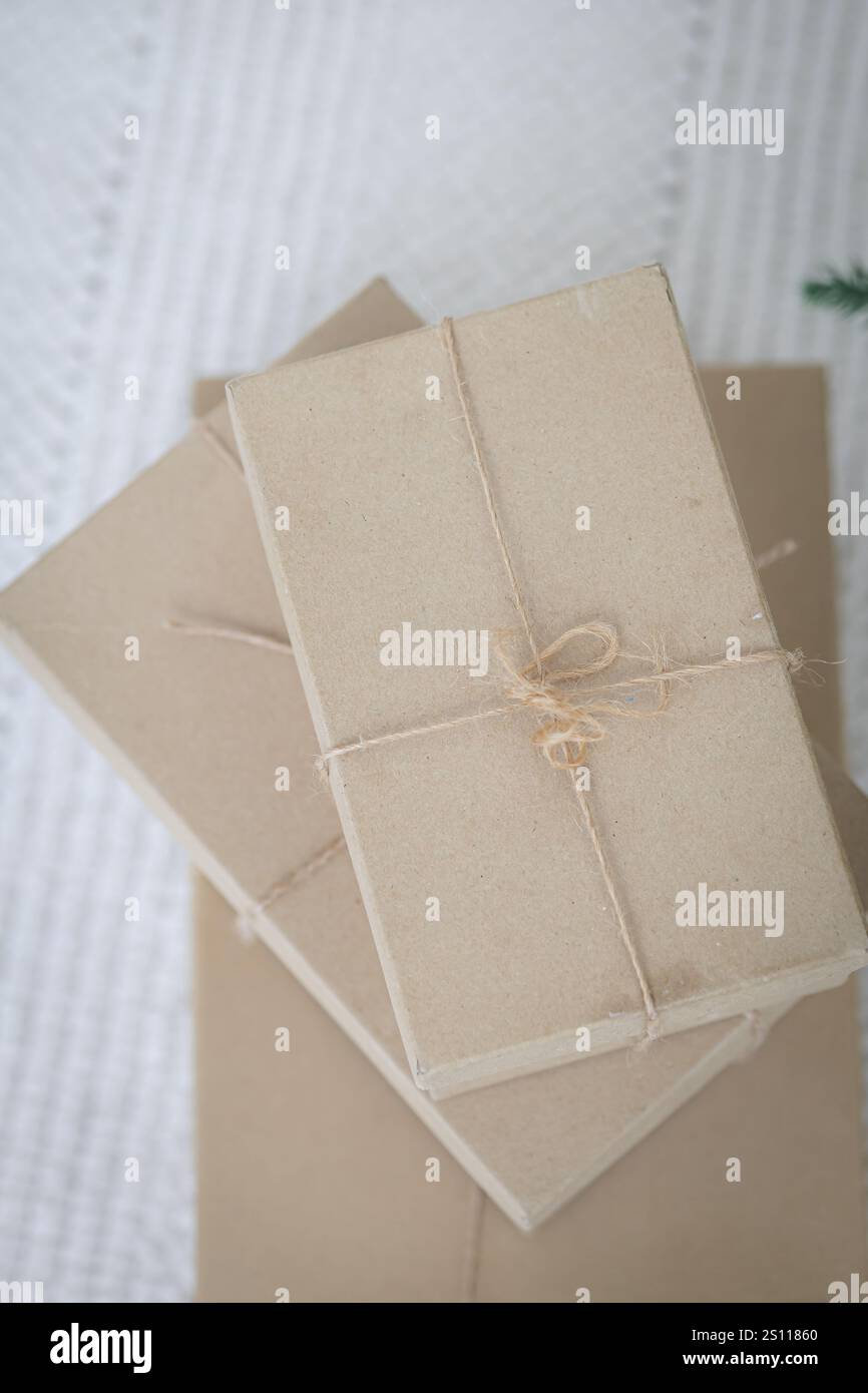 Three brown boxes stacked on top of each other. The boxes are tied together with a string Stock Photo