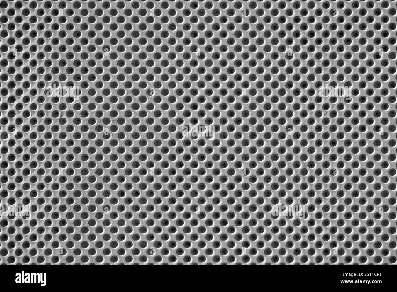 Gray concrete with hole pattern - close-up of a wall cladding Stock Photo