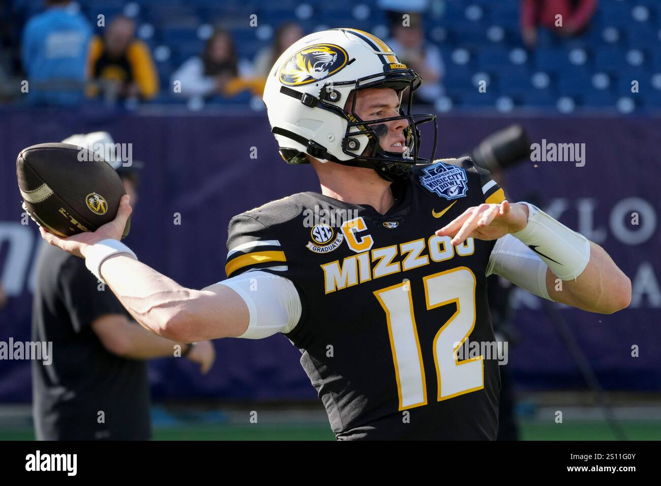 Missouri quarterback Brady Cook (12) warms up before the Music City