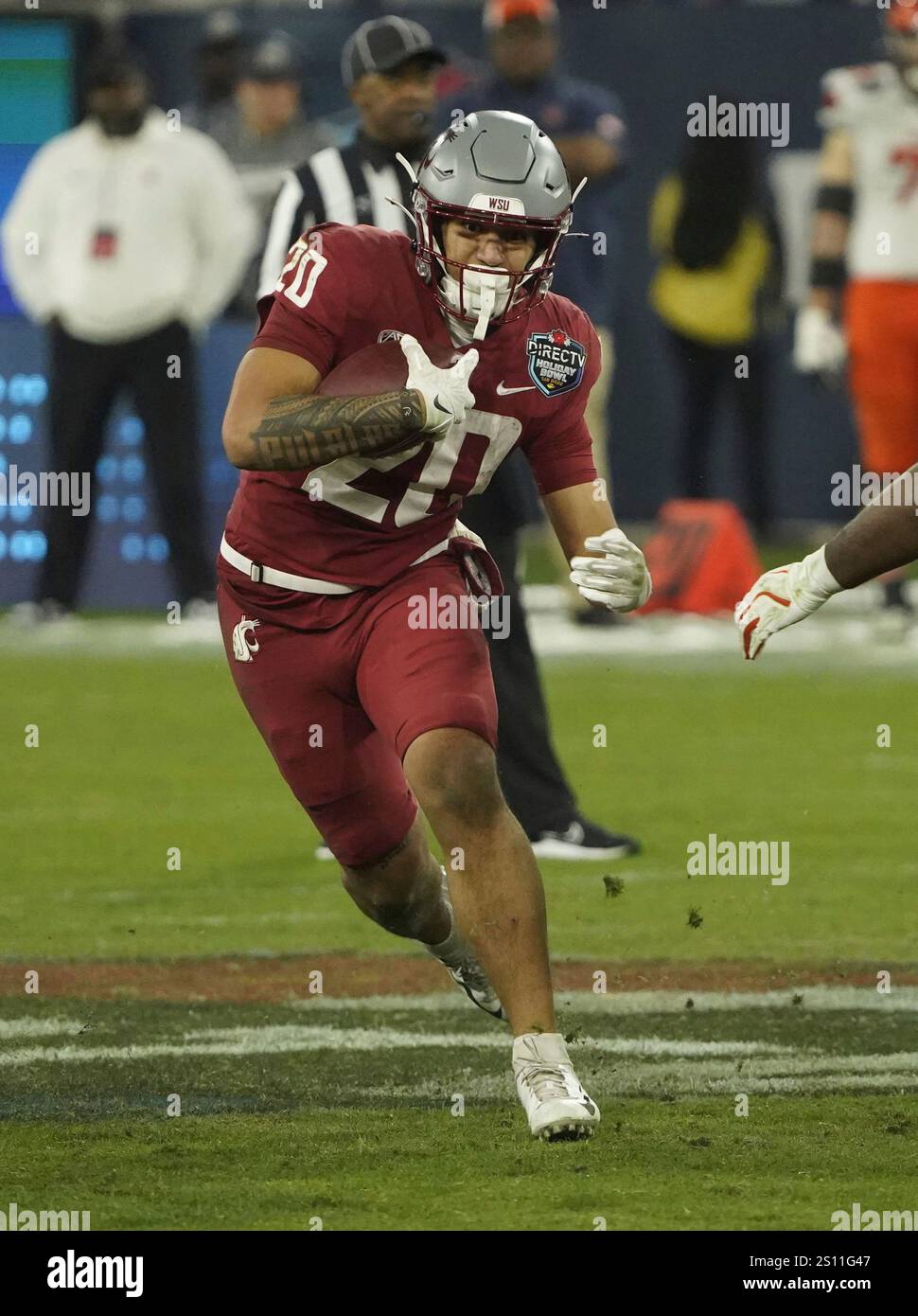 Washington State running back Leo Pulalasi (20) makes a play with the
