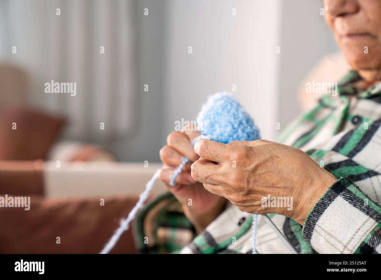old woman knitting, sitting in her armchair near the window Stock Photo ...