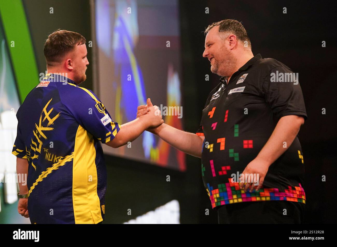 Luke Littler of England celebrates after winning his round 4 match