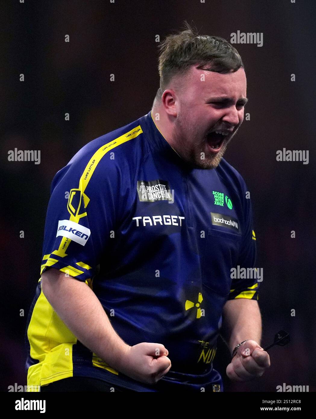 Luke Littler celebrates defeating Ryan Joyce during day thirteen of the