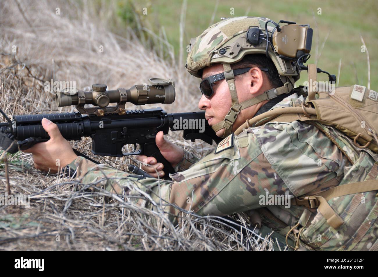 U.S. Air Force Staff Sgt. Ricardo Arias, a defender from the 908th Security Forces Squadron, looks down the optics of an M4 carbine at Maxwell Air Force Base, Alabama, Nov. 1, 2024. During a wing-wide combat readiness exercise, Arias used the optic attached to his weapon to locate potential enemy forces from a safe distance. (U.S. Air Force photo by Bradley J. Clark) Stock Photo