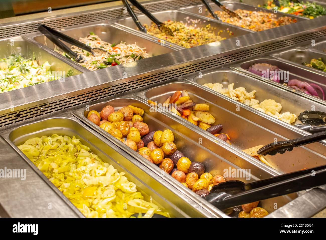 A view of several food trays in a salad bar at a local grocery store ...