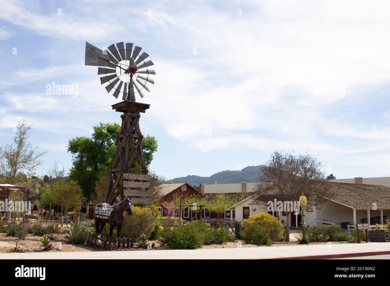 Temecula, California, United States - 04-08-2019: A view of the entrance to Vail Headquarters featuring a tall vintage windmill. Stock Photo