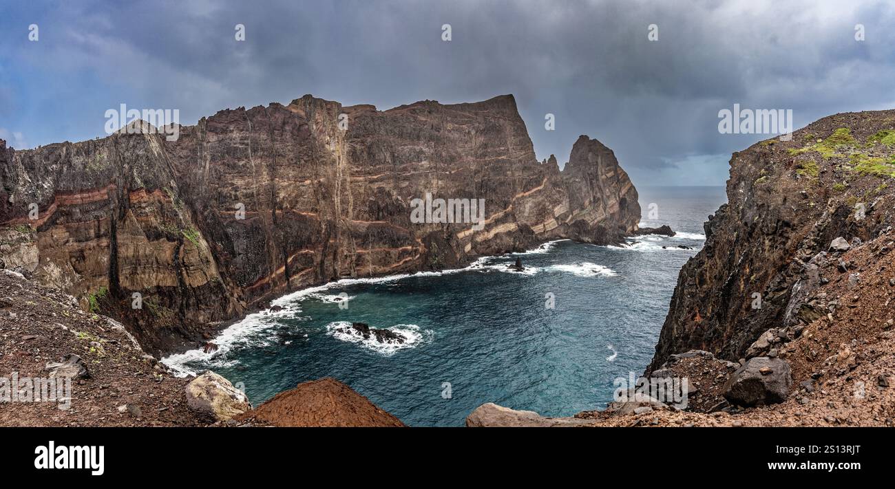 Scenic view of green cliffs leading to the ocean under moody storm ...