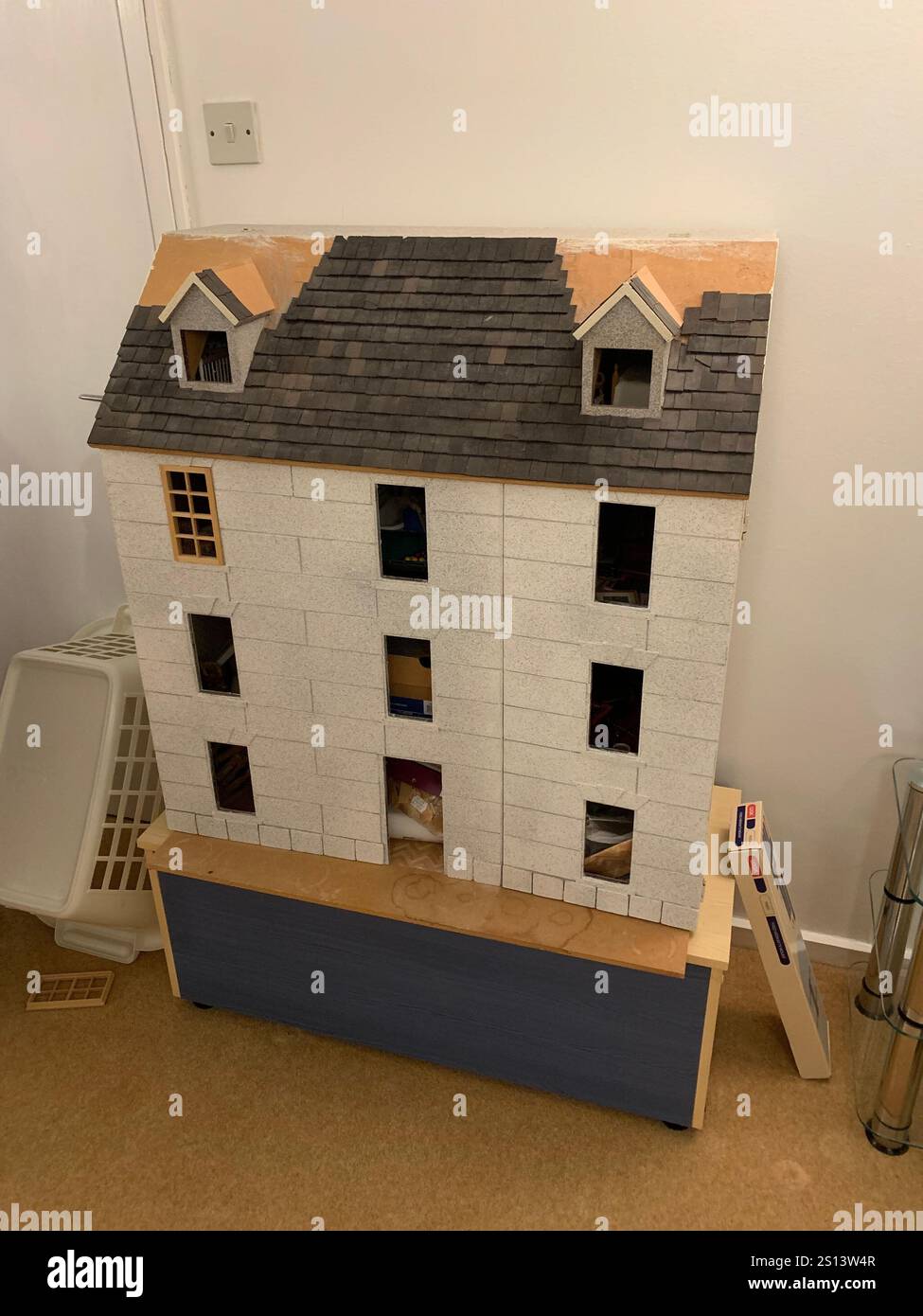 Dolls house large big working children play toy children's make made windows floor roof man looking holding make playing games game time energy - Smartphone Captured Stock Image